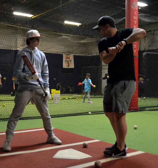 Total Skills baseball players practicing in the batting cages