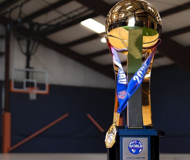 Basketball championship trophy with gold medal draped over it