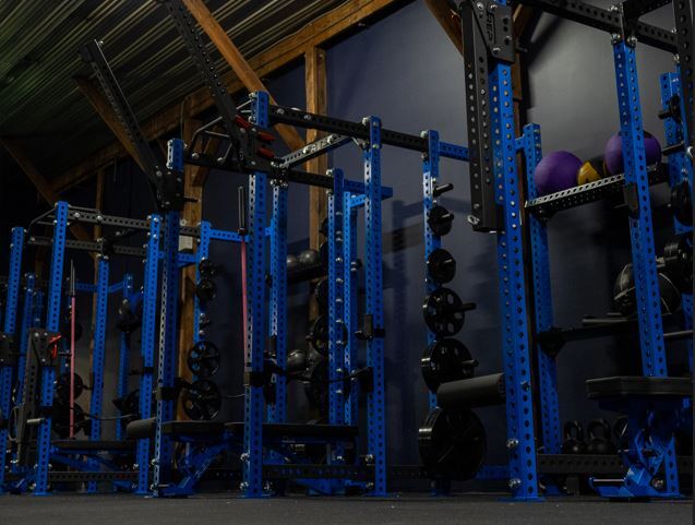 blue weight racks in dark weight room